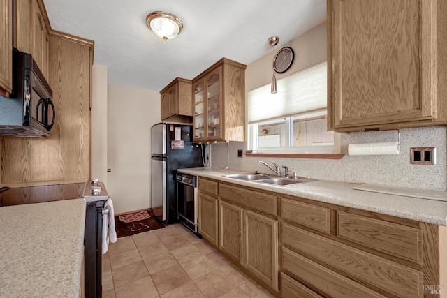 7753 N Cora Dr, Lucerne, CA 95458 - kitchen featuring a sink, black appliances, light countertops, backsplash, and glass insert cabinets