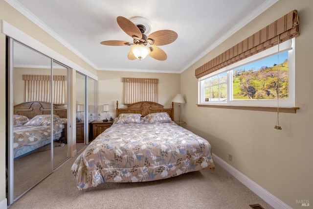 7753 N Cora Dr, Lucerne, CA 95458 - carpeted bedroom with two closets, crown molding, baseboards, and a ceiling fan