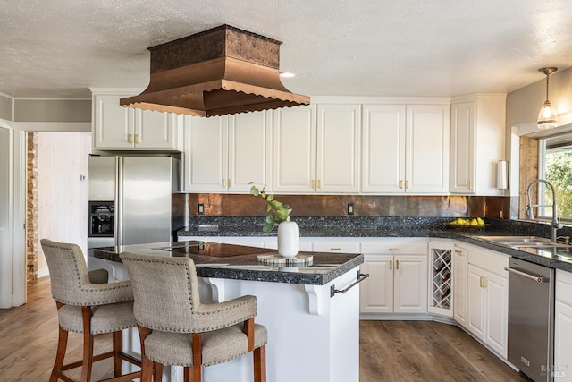 10505 Cherry Ridge Rd, Sebastopol, CA 95472 - kitchen featuring stainless steel appliances, a sink, dark wood finished floors, white cabinets, and a breakfast bar