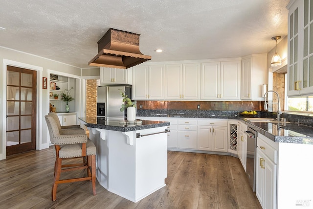 10505 Cherry Ridge Rd, Sebastopol, CA 95472 - kitchen featuring appliances with stainless steel finishes, a sink, a center island, white cabinetry, and dark wood-style floors