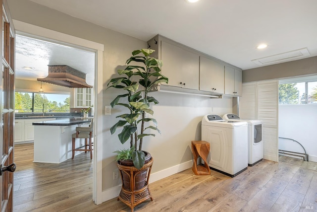 10505 Cherry Ridge Rd, Sebastopol, CA 95472 - laundry area with cabinet space, independent washer and dryer, plenty of natural light, light wood-type flooring, and recessed lighting