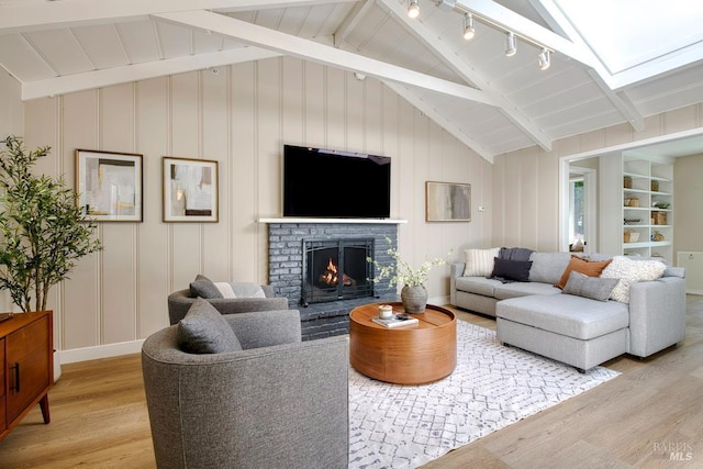 41 Salinas Ave, San Anselmo, CA 94960 - living room with light wood-type flooring, a fireplace, and a decorative wall