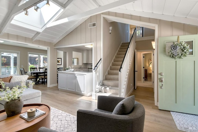 41 Salinas Ave, San Anselmo, CA 94960 - living room with light wood-style flooring, stairs, beam ceiling, a skylight, and high vaulted ceiling