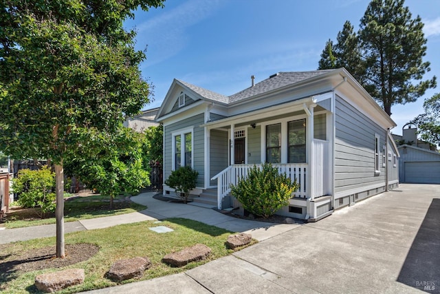 24 S University St, Healdsburg, CA 95448 - view of front facade featuring covered porch, an outdoor structure, roof with shingles, and a garage