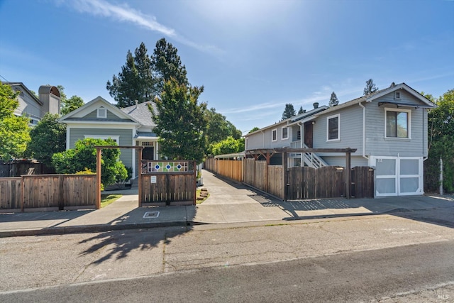 24 S University St, Healdsburg, CA 95448 - view of front of home featuring an attached garage, a fenced front yard, and concrete driveway