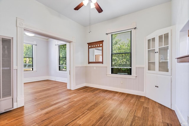 24 S University St, Healdsburg, CA 95448 - empty room with a heating unit, light wood-style flooring, ceiling fan, and wainscoting