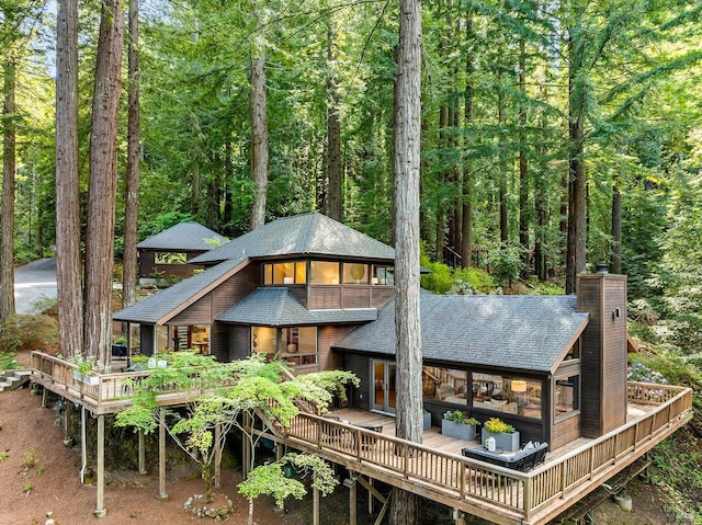 1655 Jonive Rd, Sebastopol, CA 95472 - rear view of house featuring a chimney, a shingled roof, a deck, and a wooded view