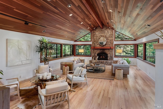 1655 Jonive Rd, Sebastopol, CA 95472 - living area featuring wood finished floors, a stone fireplace, baseboards, and wood ceiling