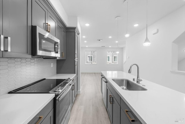 339 Pear Tree Ter Unit C, Napa, CA 94558 - kitchen with appliances with stainless steel finishes, a sink, light wood-type flooring, decorative backsplash, and light countertops