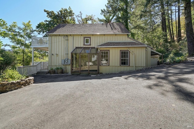 1423 Foothill Blvd, Calistoga, CA 94515 - view of front of house featuring roof with shingles, a balcony, and board and batten siding