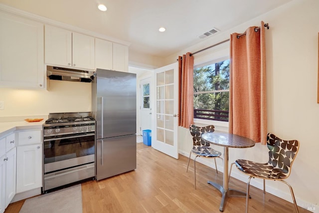 1423 Foothill Blvd, Calistoga, CA 94515 - kitchen with stainless steel appliances, under cabinet range hood, white cabinets, light wood-style floors, and recessed lighting