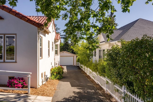 31 Laurel Ave, Petaluma, CA 94952 - view of property exterior featuring stucco siding, a garage, and an outdoor structure