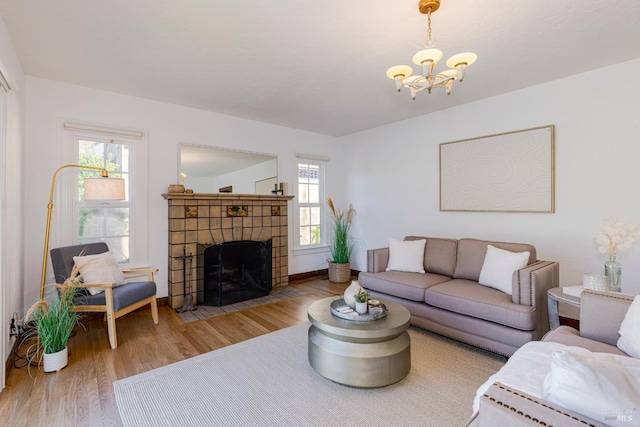 31 Laurel Ave, Petaluma, CA 94952 - living room with light wood-style flooring, a chandelier, plenty of natural light, and a tiled fireplace