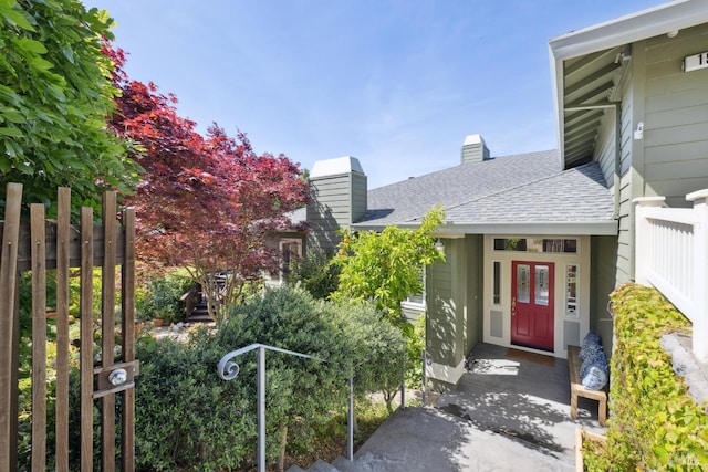 15 Upland Ln, Novato, CA 94945 - view of exterior entry featuring a chimney and roof with shingles