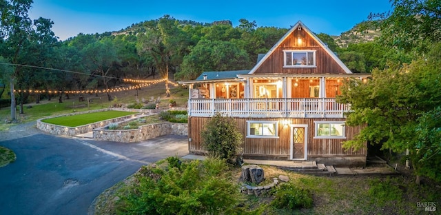 1114 Mount George Ave, Napa, CA 94558 - rear view of house with a balcony, a view of trees, and asphalt driveway