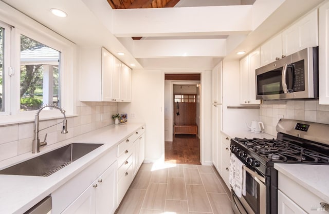1114 Mount George Ave, Napa, CA 94558 - kitchen with appliances with stainless steel finishes, a sink, white cabinetry, recessed lighting, and backsplash