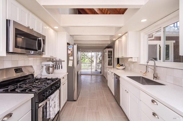 1114 Mount George Ave, Napa, CA 94558 - kitchen featuring appliances with stainless steel finishes, a sink, white cabinets, backsplash, and light countertops