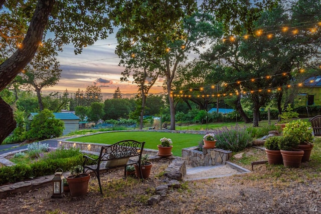 1114 Mount George Ave, Napa, CA 94558 - yard at dusk featuring a lawn and an outdoor structure
