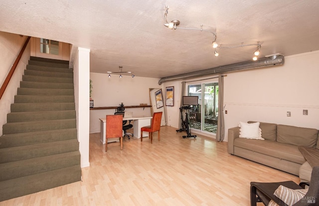 1114 Mount George Ave, Napa, CA 94558 - living room featuring light wood finished floors, stairway, and a textured ceiling