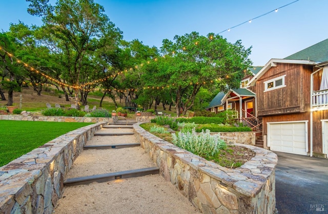 1114 Mount George Ave, Napa, CA 94558 - view of green lawn featuring a garage, stairway, and asphalt driveway