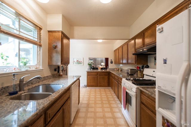 2698 Reuben Ct, Napa, CA 94558 - kitchen with white appliances, under cabinet range hood, a sink, brown cabinets, and light floors