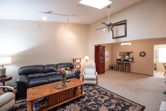 2698 Reuben Ct, Napa, CA 94558 - carpeted living area with rail lighting, a ceiling fan, and high vaulted ceiling