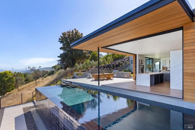 2215 Vistazo St E, Tiburon, CA 94920 - view of pool featuring an outdoor kitchen, a patio area, an infinity pool, and outdoor dining area