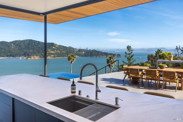 2215 Vistazo St E, Tiburon, CA 94920 - view of patio with a sink, a water and mountain view, and outdoor dining area
