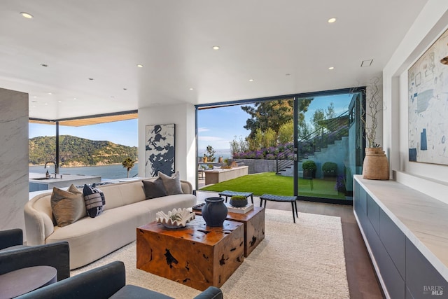 2215 Vistazo St E, Tiburon, CA 94920 - living room featuring floor to ceiling windows, recessed lighting, wood finished floors, and a mountain view