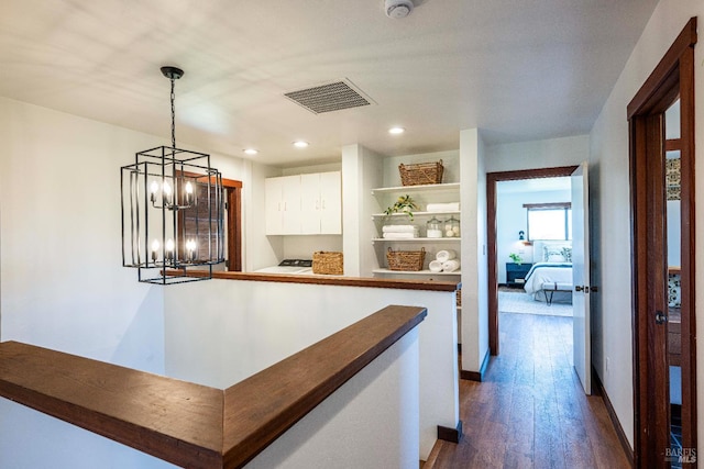 5900 Blank Rd, Sebastopol, CA 95472 - kitchen with white cabinets, dark wood-type flooring, a chandelier, open shelves, and dark countertops
