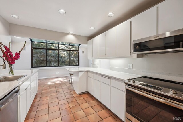 280 Oakcrest Rd, San Anselmo, CA 94960 - kitchen with appliances with stainless steel finishes, a sink, light countertops, white cabinets, and recessed lighting