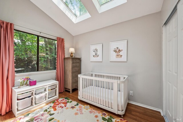280 Oakcrest Rd, San Anselmo, CA 94960 - bedroom featuring a skylight, vaulted ceiling, a closet, wood finished floors, and a nursery area