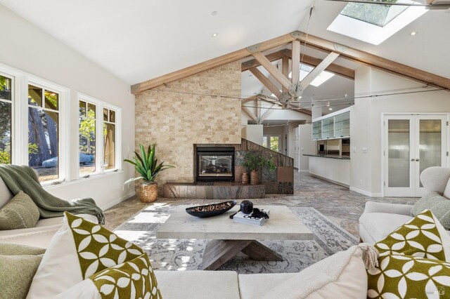 41 Cypress Rd, Point Reyes Station, CA 94956 - living area with baseboards, plenty of natural light, high vaulted ceiling, a tile fireplace, and french doors