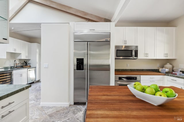 41 Cypress Rd, Point Reyes Station, CA 94956 - kitchen featuring appliances with stainless steel finishes, wood counters, wine cooler, beam ceiling, and white cabinetry