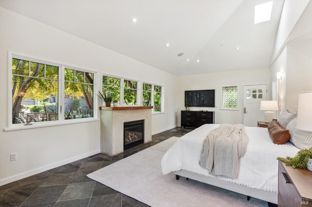 41 Cypress Rd, Point Reyes Station, CA 94956 - bedroom featuring baseboards, high vaulted ceiling, a glass covered fireplace, stone finish flooring, and recessed lighting