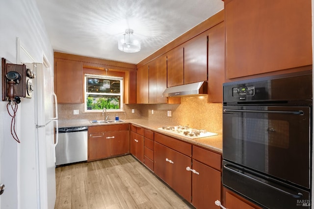 1225 Arkansas St, Vallejo, CA 94590 - kitchen featuring white appliances, under cabinet range hood, a sink, a warming drawer, and light wood finished floors