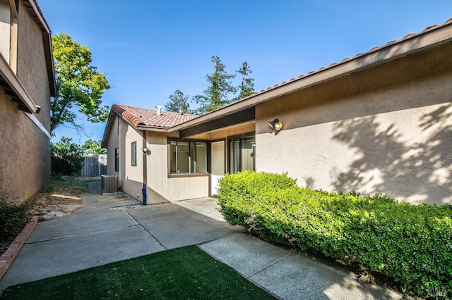2728 Almondwood Way, Fairfield, CA 94534 - view of side of property featuring cooling unit, a tiled roof, stucco siding, and a patio area