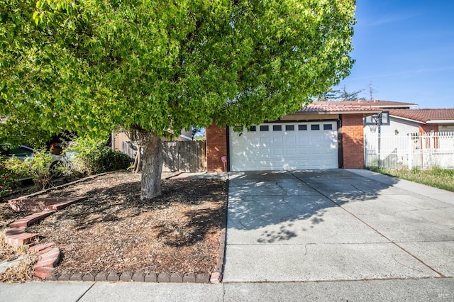 2728 Almondwood Way, Fairfield, CA 94534 - obstructed view of property with concrete driveway, a tile roof, and brick siding