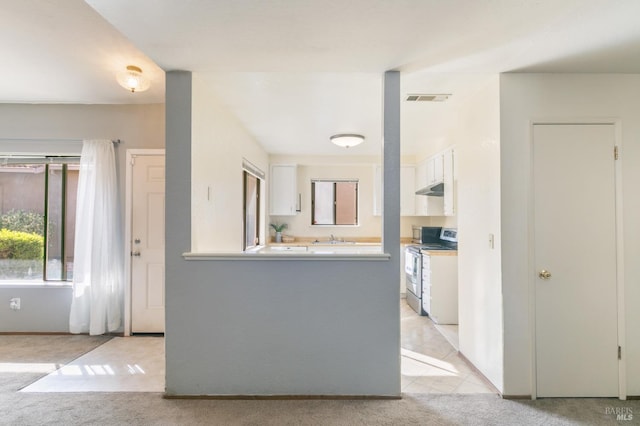 2728 Almondwood Way, Fairfield, CA 94534 - kitchen with stainless steel range oven, light carpet, and white cabinetry