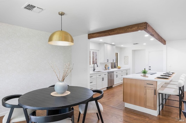 1109 Broadmoor Dr, Napa, CA 94558 - kitchen with stainless steel dishwasher, recessed lighting, wood finished floors, light countertops, and white cabinets