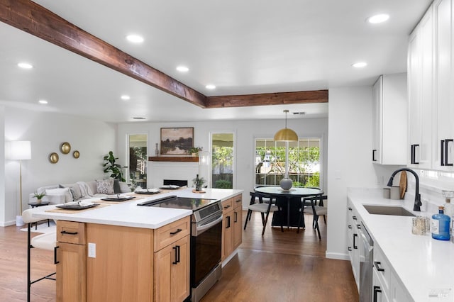 1109 Broadmoor Dr, Napa, CA 94558 - kitchen with stainless steel appliances, a sink, dark wood-style flooring, a fireplace, and a center island