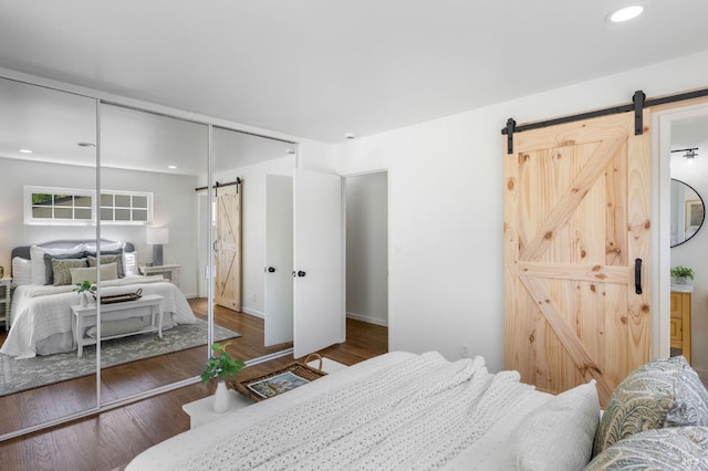 1109 Broadmoor Dr, Napa, CA 94558 - bedroom with a barn door, a closet, wood finished floors, baseboards, and recessed lighting