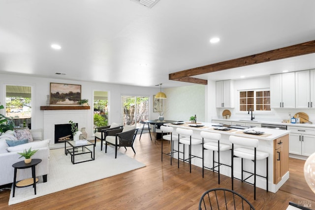 1109 Broadmoor Dr, Napa, CA 94558 - kitchen with light countertops, a kitchen bar, white cabinets, recessed lighting, and a kitchen island