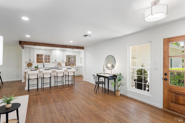 1109 Broadmoor Dr, Napa, CA 94558 - kitchen featuring white cabinets, light countertops, baseboards, a breakfast bar area, and recessed lighting