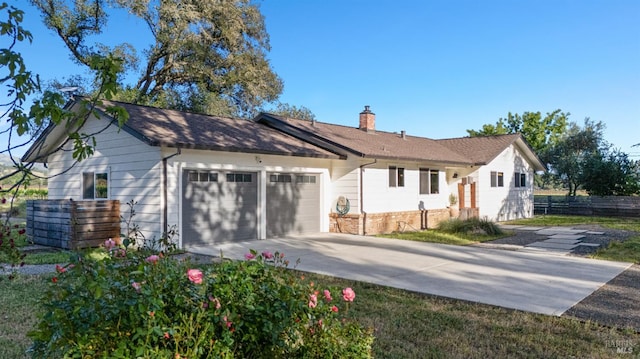 21800 River Rd, Geyserville, CA 95441 - view of front facade featuring a garage, concrete driveway, a chimney, and brick siding