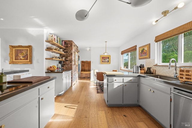 21800 River Rd, Geyserville, CA 95441 - kitchen featuring dark countertops, a sink, dishwasher, open shelves, and light wood-style floors