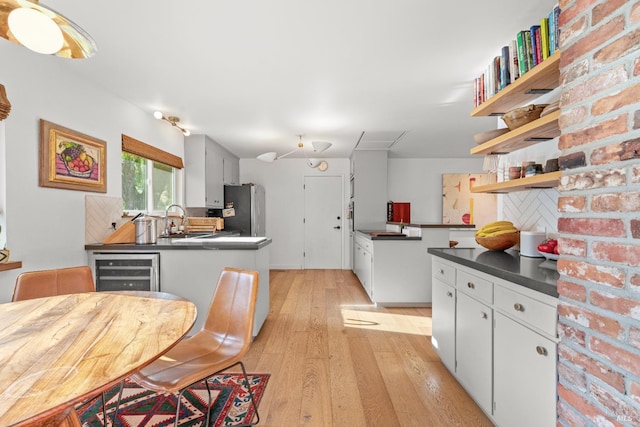 21800 River Rd, Geyserville, CA 95441 - kitchen with freestanding refrigerator, dark countertops, open shelves, wine cooler, and light wood finished floors