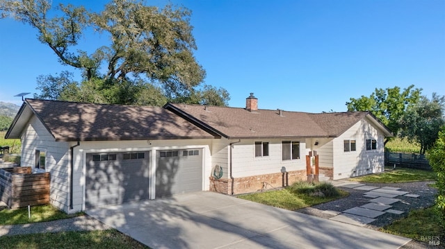 21800 River Rd, Geyserville, CA 95441 - ranch-style home with an attached garage, a chimney, driveway, a shingled roof, and brick siding