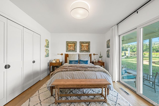 21800 River Rd, Geyserville, CA 95441 - bedroom with access to exterior, light wood-type flooring, and a closet