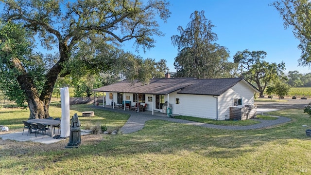 21800 River Rd, Geyserville, CA 95441 - rear view of house with a yard, a chimney, a fire pit, a patio, and covered porch